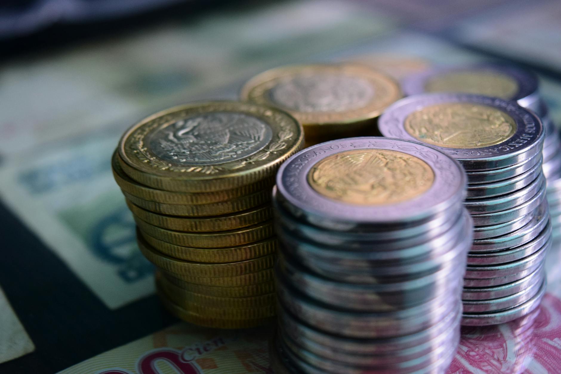 stacks of silver and gold coins in close up photography